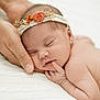 newborn, baby, sleeping, headband, hand, flower, blanket, soft, skin, peaceful, closeup, infant, cute, resting, gentle, portrait, human, child, tender, warm