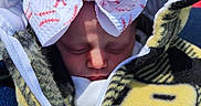 Revvlynn is registered to the contest to win money with this photo: baby, sleeping, bow, headwear, blanket, zipper, face, infant, cozy, pattern, clothing, closeup, child, cute, warm, resting, soft, outdoor, young, portrait