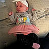 Revvlynn is registered to the contest to win money with this photo: baby, infant, headband, bow, pink_tutu, leggings, socks, mattress, pattern, cute, small_fists, lying_down, clothing, earrings, indoor, child, portrait, colorful_text, soft_lighting, adorable