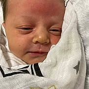 Revvlynn is registered to the contest to win money with this photo: baby, newborn, infant, face, wrapped, blanket, stars, closeup, sleepy, cute, skin, portrait, human, child, soft, cozy, young, newborn_baby, expression, resting