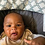 Amir joined the competition — help win amazing prizes! baby, child, infant, face, hand, seat, blanket, pattern, clothing, indoor, curious, expression, closeup, person, young, cute, soft, comfort, skin, portrait