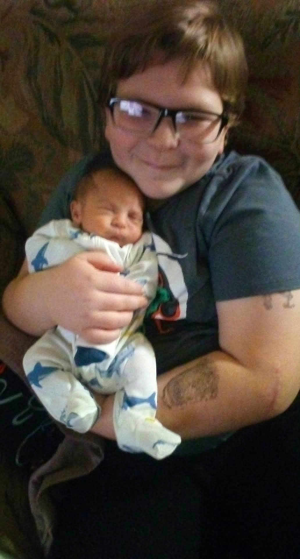 Cazmair joined the competition — help win amazing prizes! child, baby, glasses, infant, sleeping, holding, onesie, shark_pattern, smile, person, portrait, couch, home, comfort, toddler, family, indoor, clothing, happy, young