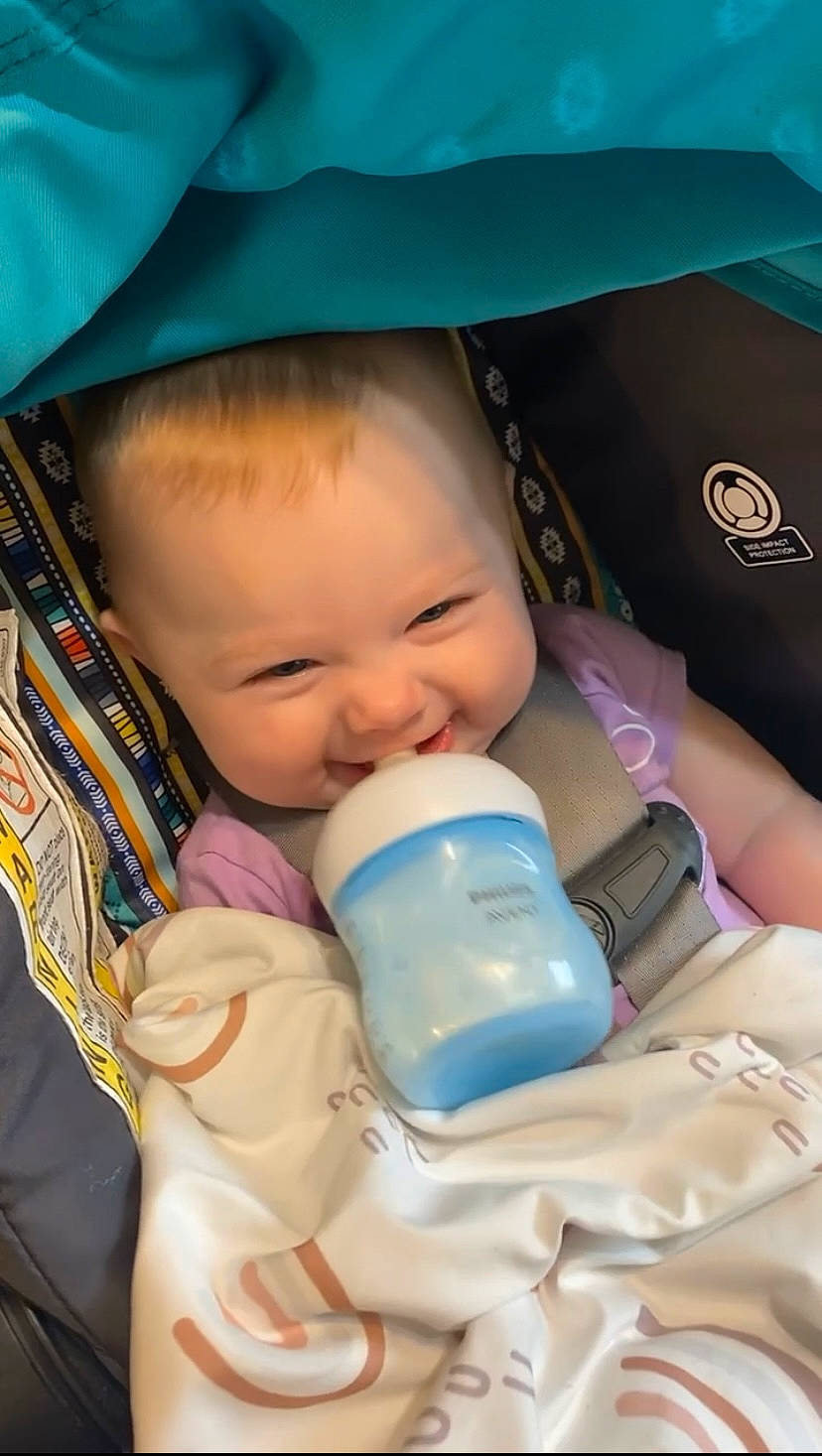 Emilynn is registered to the contest to win money with this photo: baby, baby_toddler_clothing, blue, cheek, child, chin, comfort, drinkware, eye, eyebrow, eyelash, face, head, iris, joy, mouth, nose, person, plastic_bottle, product