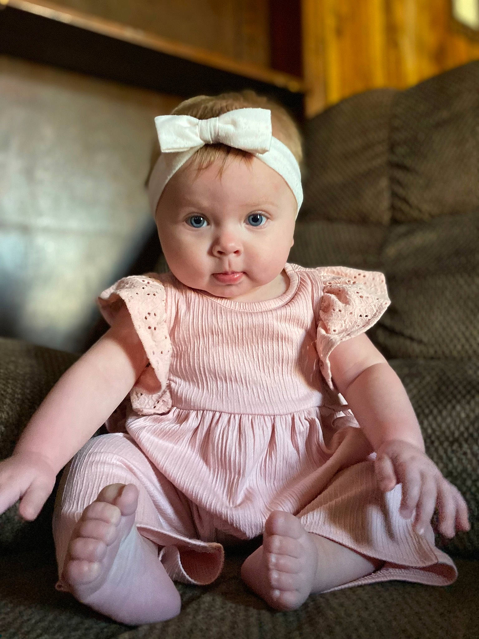 Emilynn is registered to the contest to win money with this photo: baby, baby_toddler_clothing, cheek, child, chin, day_dress, embellishment, eye, fashion_accessory, flash_photography, headband, headpiece, iris, jewellery, lip, pattern, person, sitting, skin, sleeve