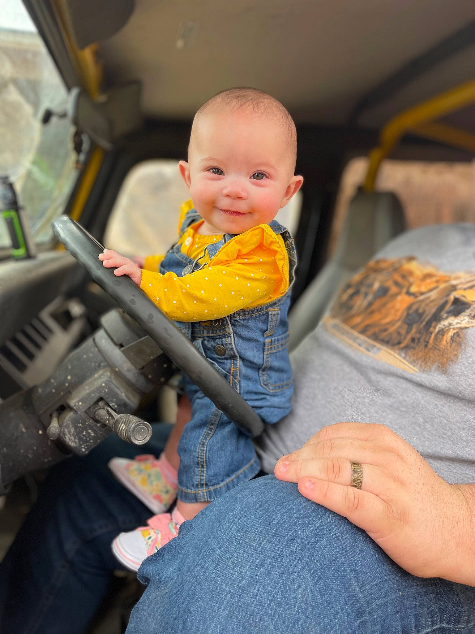 Helen is registered to the contest to win money with this photo: automotive_design, baby, car_seat, child, comfort, denim, finger, fun, hand, jeans, joy, lap, leg, motor_vehicle, person, sitting, skin, smile, thigh, toddler