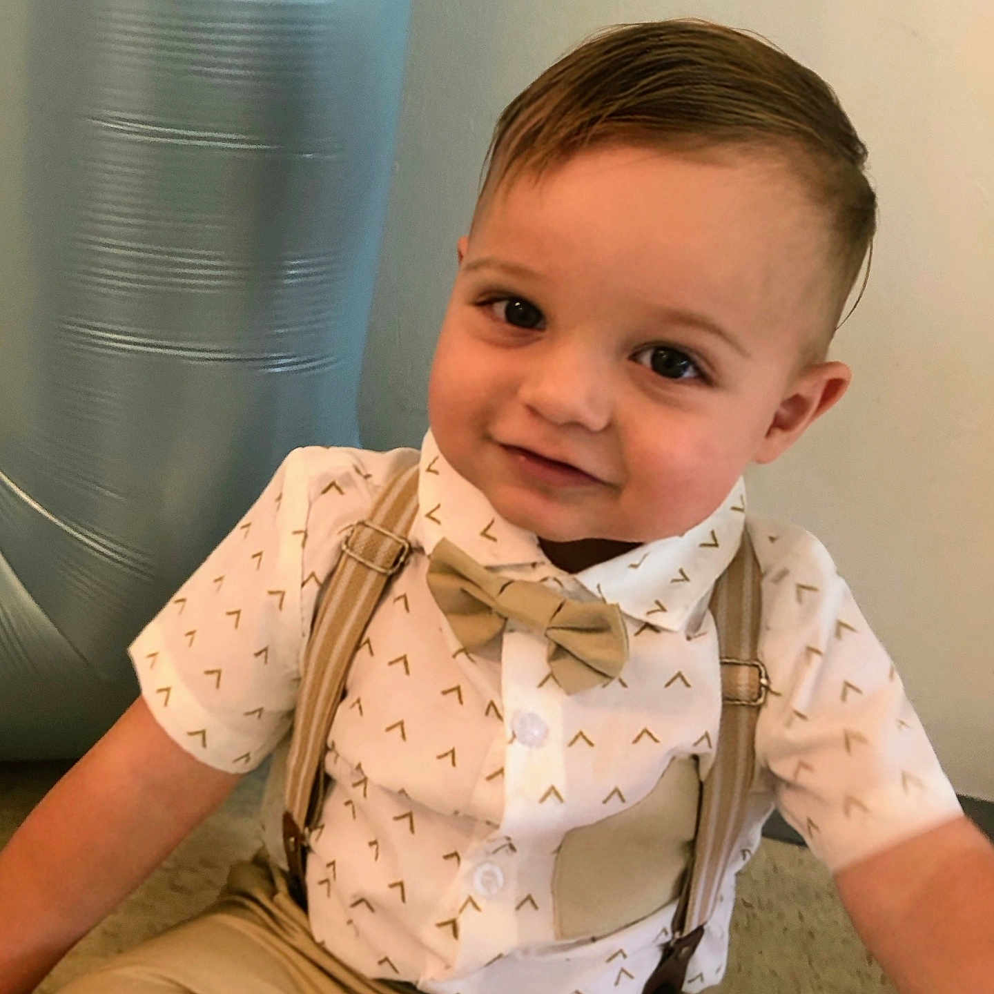Asher is registered to the contest to win money with this photo: accessories, baby, blonde, brownhair, clothing, coat, face, formalwear, hair, happy, head, person, photography, portrait, scarf, sitting, sleeve, smile, suspenders, tie