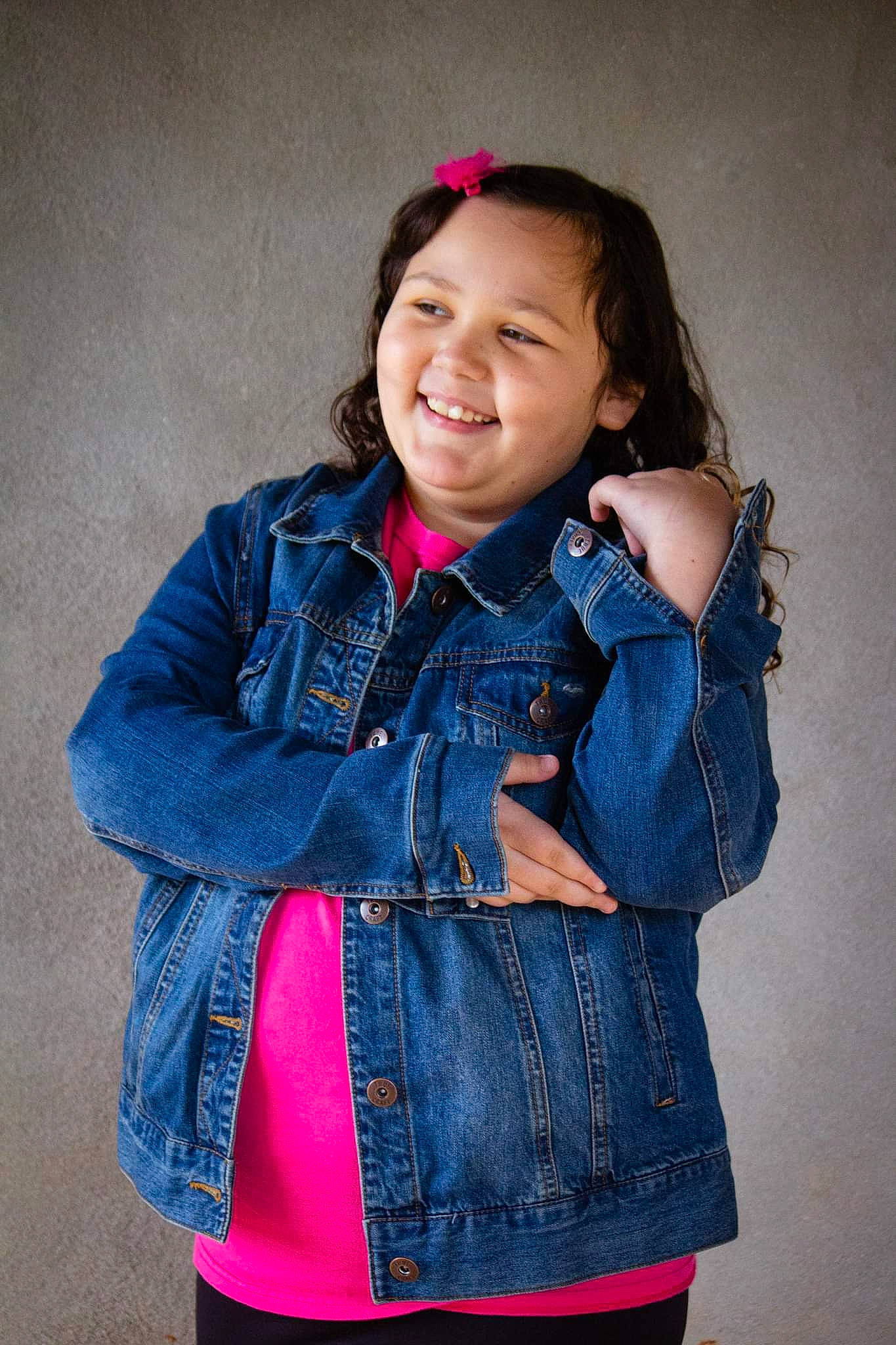 Emma is registered to the contest to win money with this photo: arm, collar, cool, denim, fashion, flash_photography, gesture, happy, jacket, joy, lip, neck, outerwear, person, pink, shoulder, skin, sleeve, smile, standing