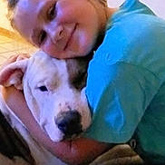 Clyde is registered to the contest to win money with this photo: child, dog, hug, smile, indoor, affection, pet, friendship, closeup, portrait, comfort, casual_clothing, light_blue_shirt, large_dog, face, skin, animal, human, cuddle, warmth