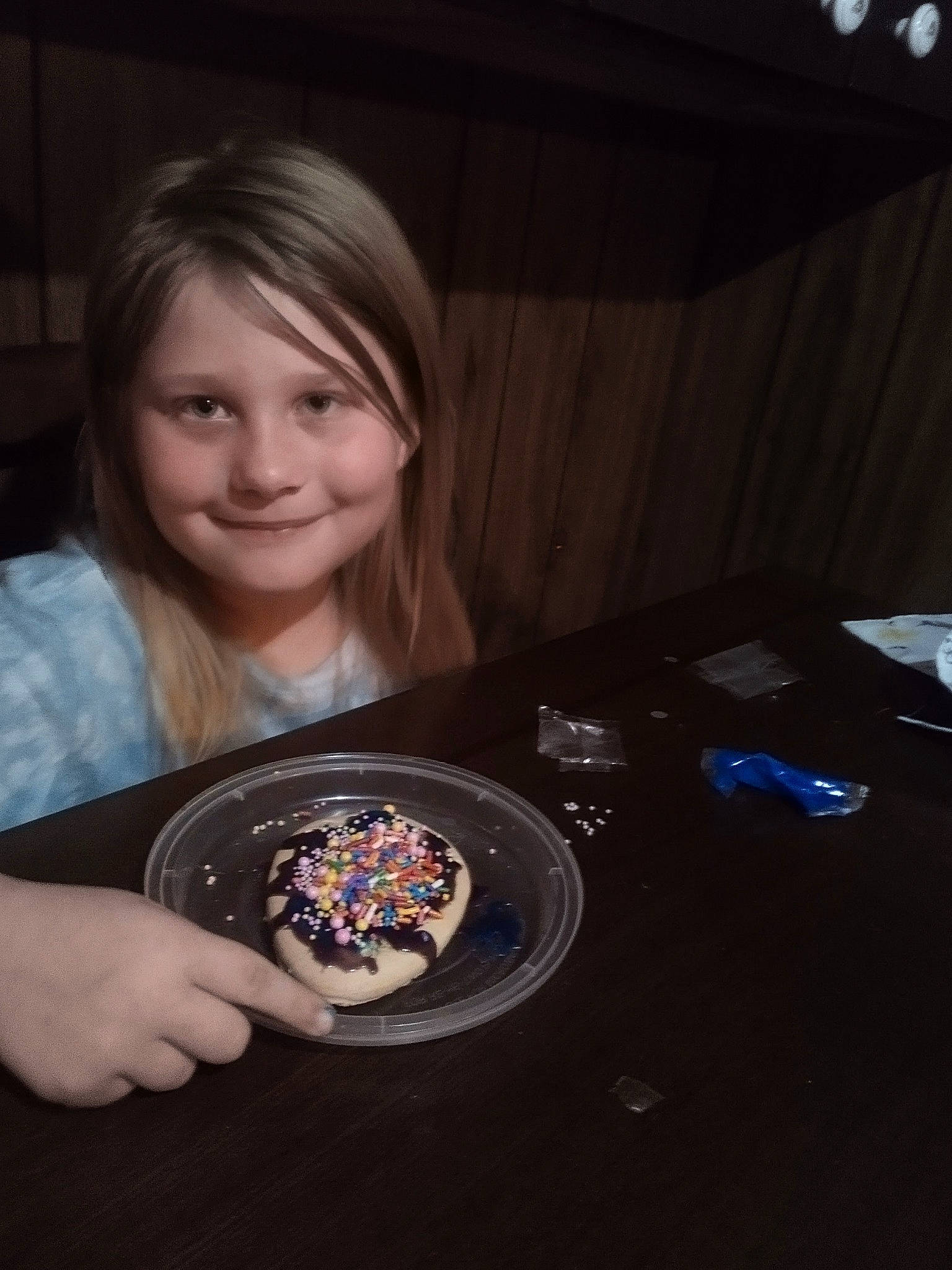 Tessa joined the competition — help win amazing prizes! audio_equipment, automotive_design, automotive_tire, automotive_wheel_system, brown_hair, chair, circle, darkness, dessert, electronic_device, flash_photography, fun, gadget, iris, joy, person, smile, t_shirt, table, tire