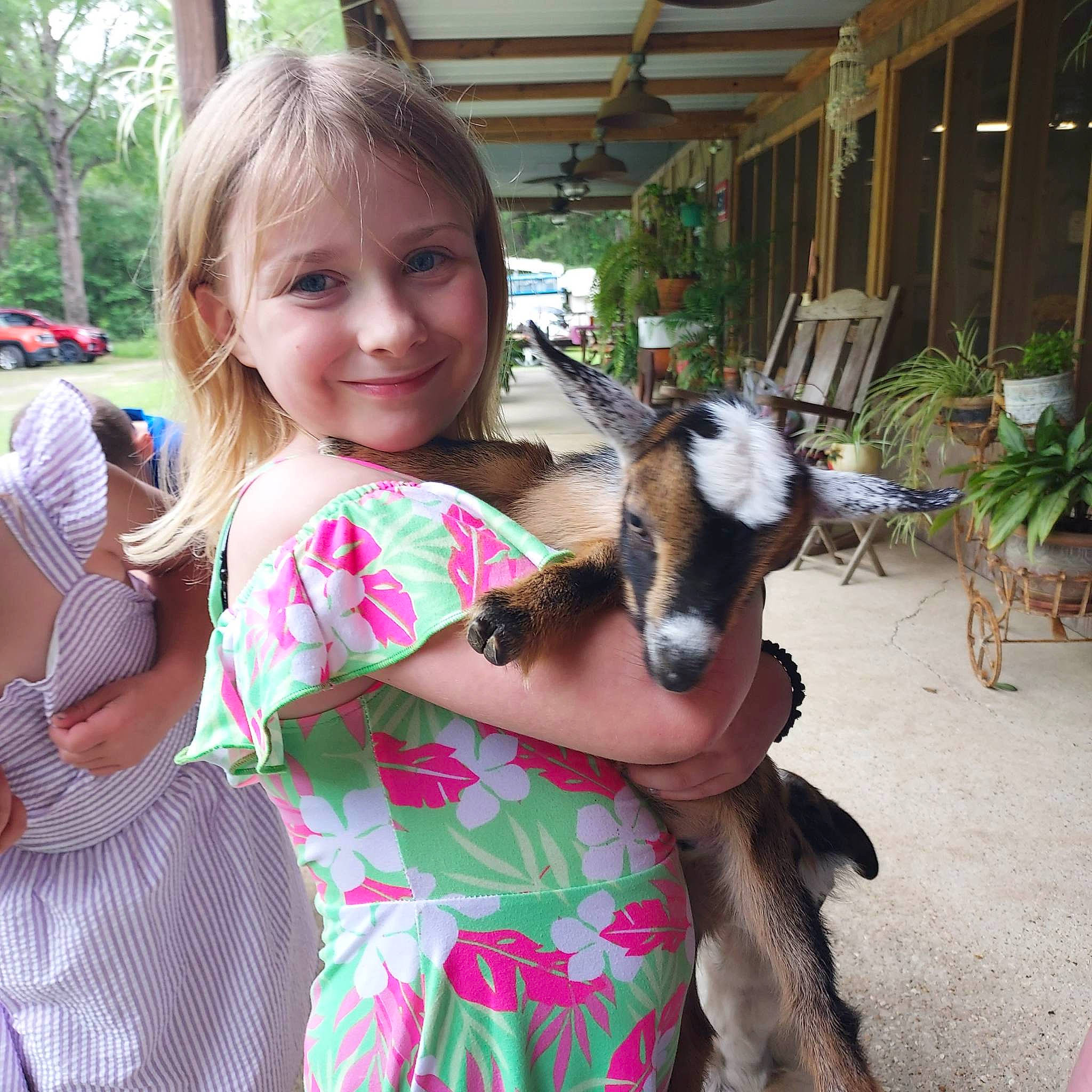 Renee joined the competition — help win amazing prizes! child, ear, event, facial_expression, fawn, fun, goat, goat_antelope, happy, houseplant, iris, joy, leisure, livestock, person, plant, sharing, smile, t_shirt, toddler