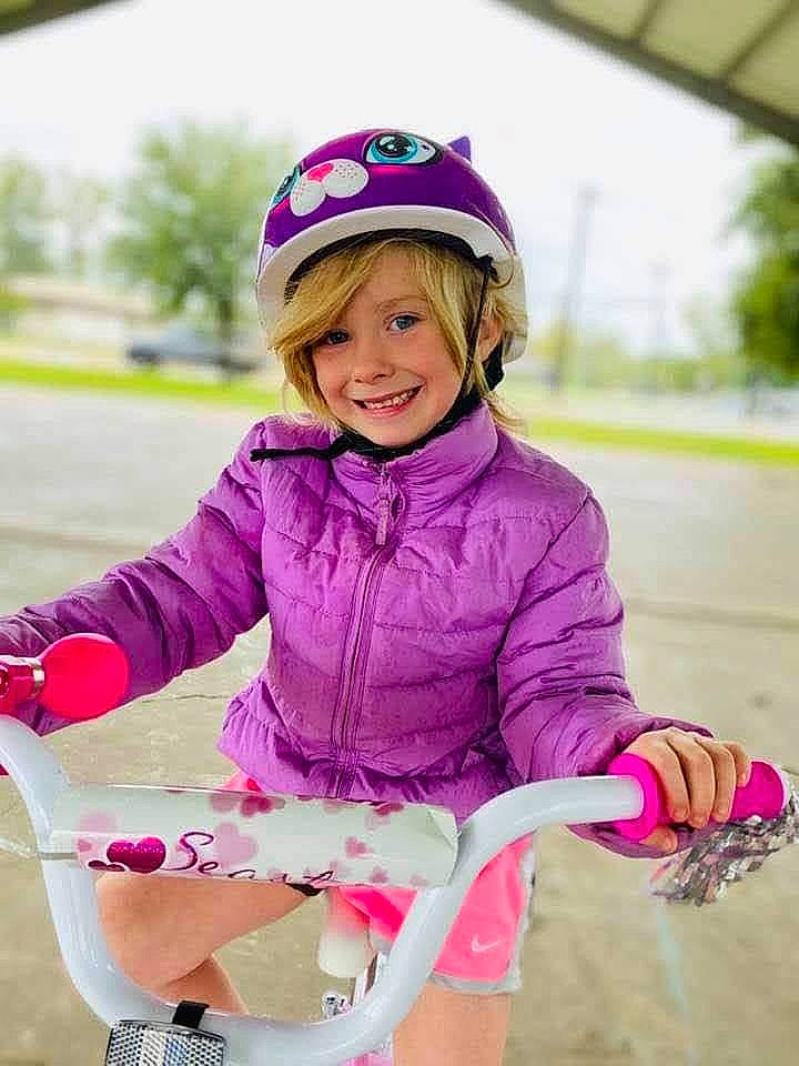 Renee joined the competition — help win amazing prizes! baby_toddler_clothing, cap, child, face, fun, happy, headwear, helmet, human_leg, joy, leisure, magenta, person, personal_protective_equipment, pink, purple, recreation, sitting, smile, sock