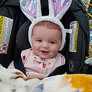 Everleigh joined the competition — help win amazing prizes! baby, blanket, bunny_ears, car_seat, child, cozy, cute, face, happy, headwear, indoor, infant, person, pink_clothing, portrait, seatbelt, shopping_cart, smile, soft_toys, warning_labels