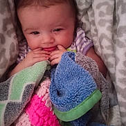 Everleigh joined the competition — help win amazing prizes! baby, blanket, blue, colorful_blanket, cozy, cute, expression, face, fingers, fuzzy, green, hand, infant, patterned_blanket, pink, portrait, purple, soft_lighting, wrapped, young_child