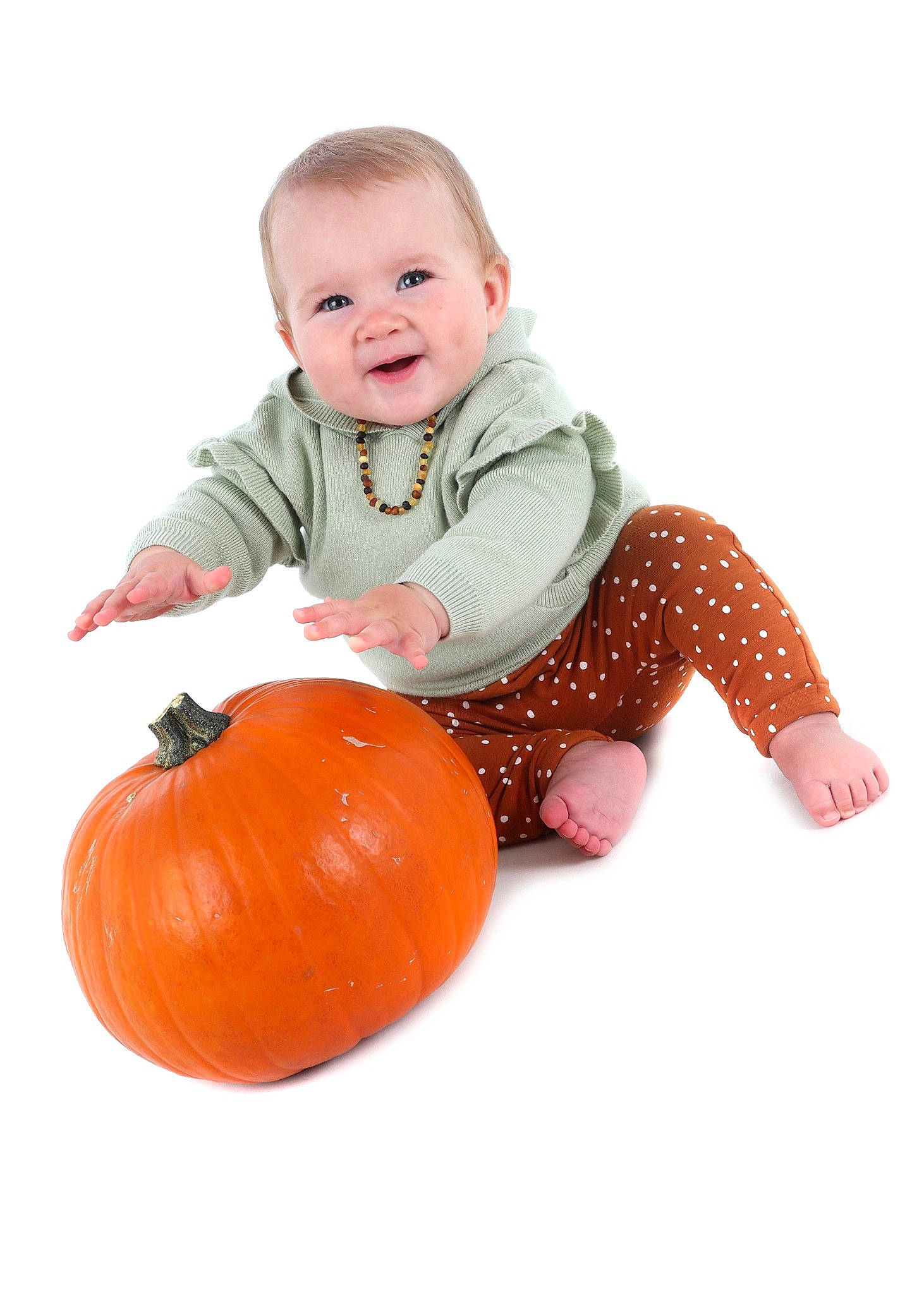 Estella is registered to the contest to win money with this photo: baby, baby_toddler_clothing, calabaza, child, flooring, happy, jacket, natural_foods, orange, person, produce, pumpkin, sitting, sleeve, smile, squash, standing, t_shirt, toddler, vegetable