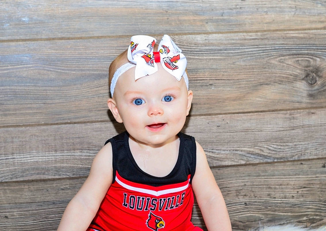 Rayna is registered to the contest to win money with this photo: baby, baby_toddler_clothing, cap, child, child_model, clothing, crown, fashion_accessory, hair_accessory, headband, headgear, person, t_shirt, toddler