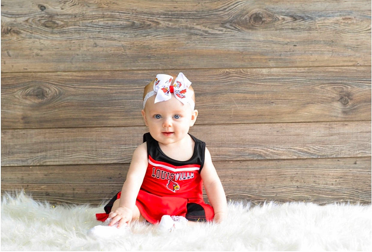Rayna is registered to the contest to win money with this photo: baby, child, child_model, crown, fashion_accessory, hair_accessory, happy, headgear, person, photograph, photography, play, portrait_photography, red, sitting, smile, toddler, vacation