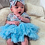 baby, infant, child, blue_tutu, headband, floral_pattern, blanket, soft_texture, curious_expression, sitting, indoors, cute, small_hands, small_feet, portrait, clothing, fabric, cozy, comfortable, skin