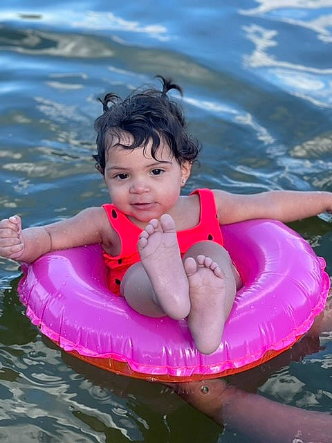 Renessme is registered to the contest to win money with this photo: aqua, baby, baby_float, baby_products, bathing, beauty, child, facial_expression, fun, happy, inflatable, leisure, outdoor_recreation, person, personal_protective_equipment, pink, recreation, swimming_pool, toddler, vertebrate