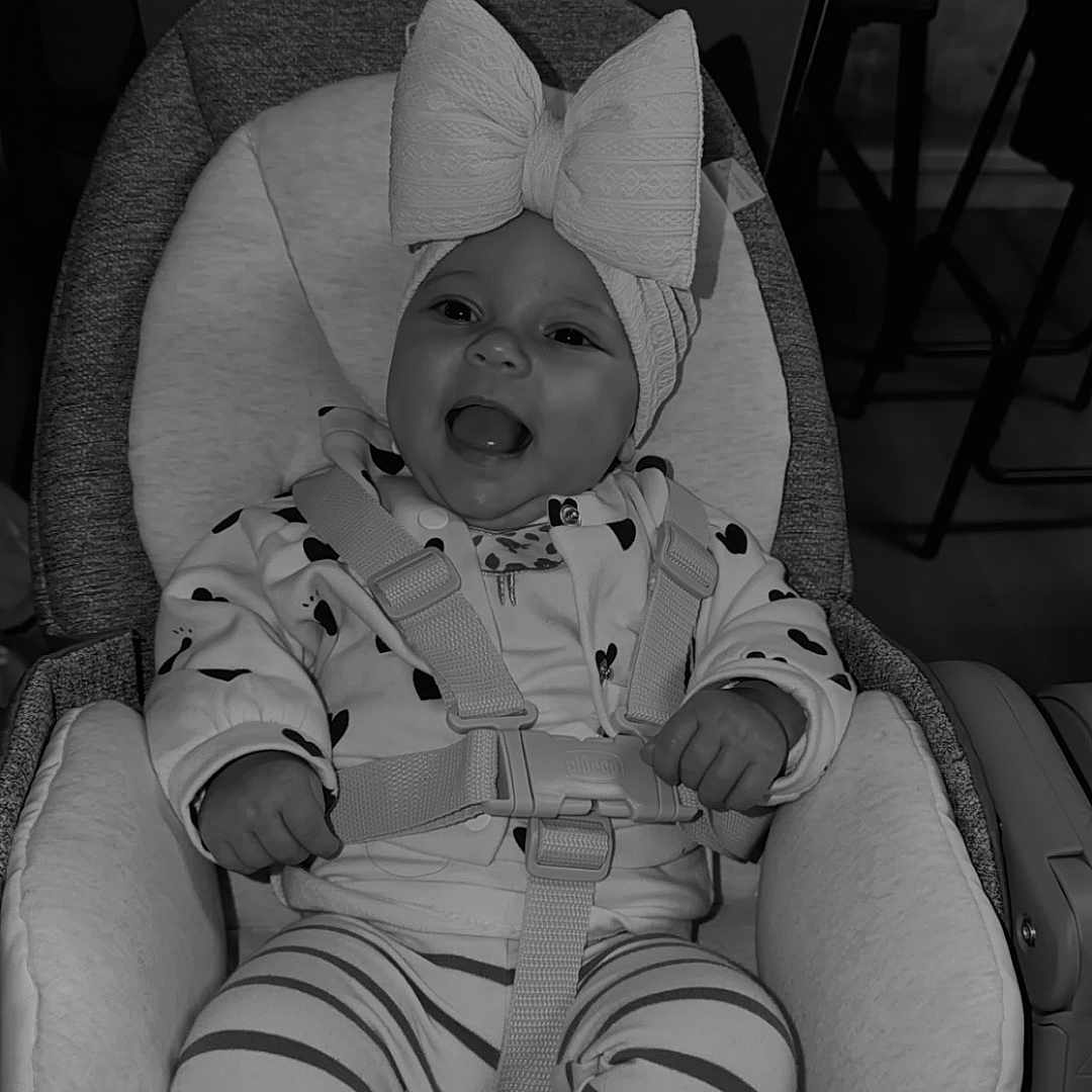 Leylee participe au concours pour gagner de l'argent avec cette photo : apparel, baby, bow, car_seat, child, clothing, cute, fabric, footwear, happy, headband, indoors, infant, person, safety_harness, shoes, sitting, smiling, striped_pants, young_child