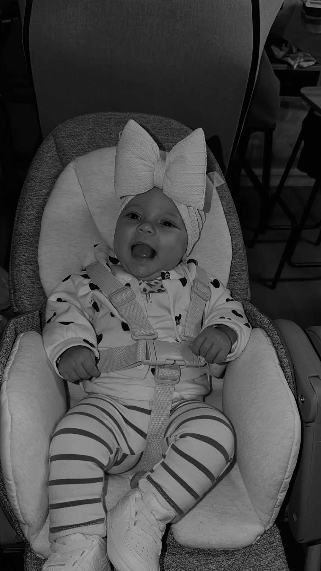 Leylee participe au concours pour gagner de l'argent avec cette photo : baby, child, car_seat, headband, bow, smiling, happy, clothing, striped_pants, shoes, sitting, infant, cute, indoors, fabric, safety_harness, person, footwear, apparel, young_child