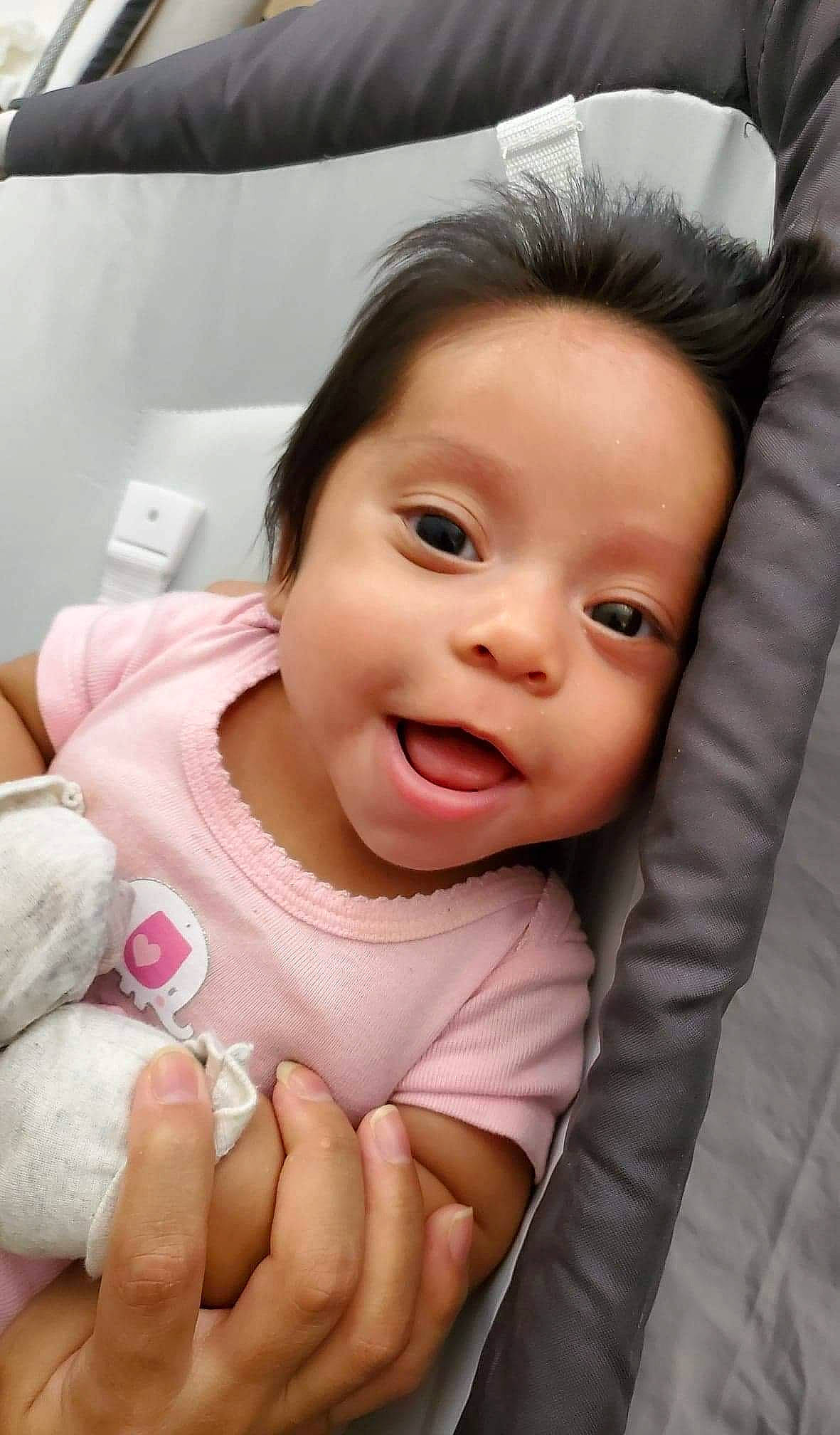 Lorelai joined the competition — help win amazing prizes! baby, baby_toddler_clothing, cheek, chin, comfort, eyebrow, facial_expression, finger, gesture, happy, lip, mouth, nose, person, pink, product, skin, sleeve, smile, toddler