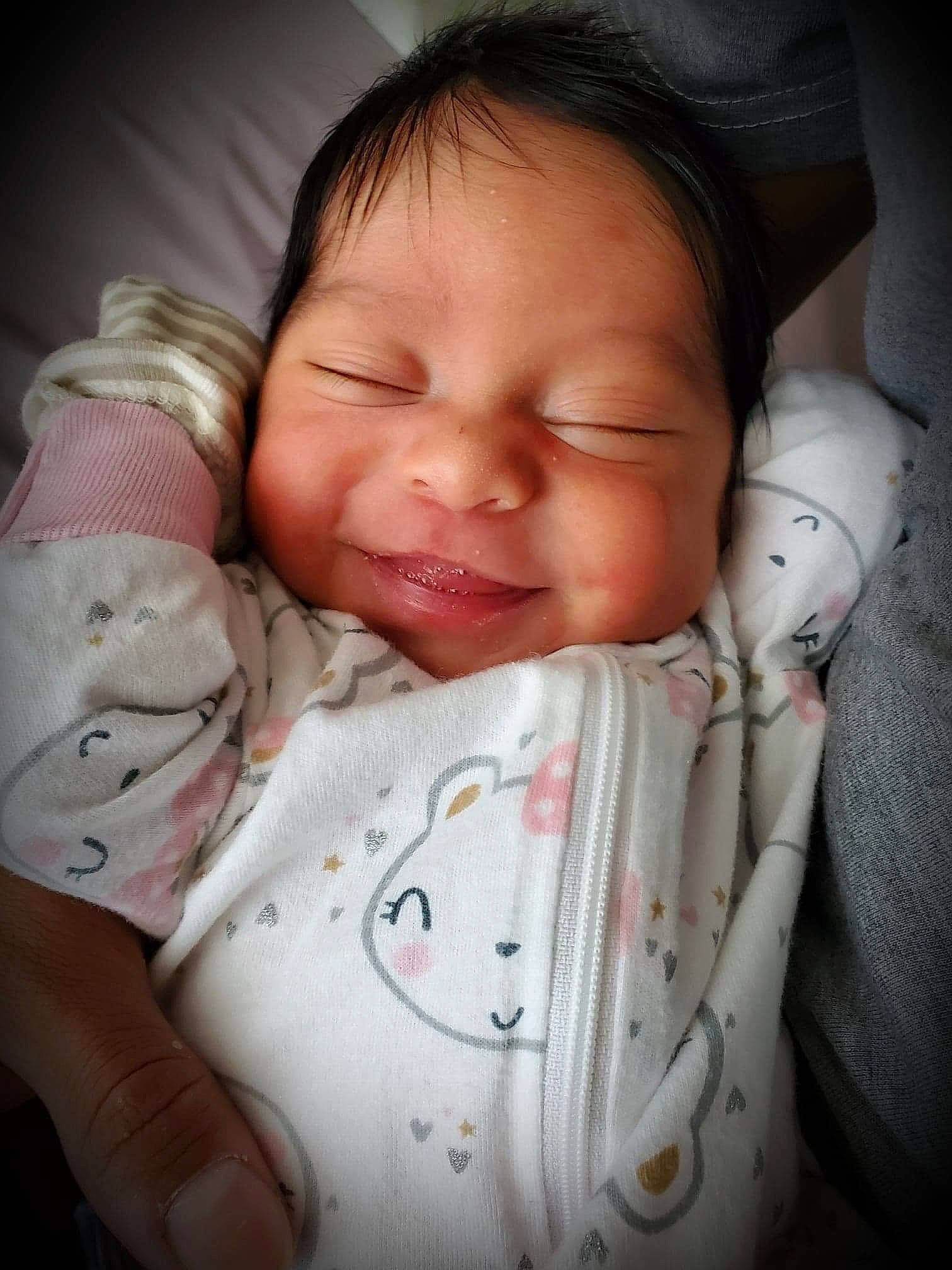 Lorelai is registered to the contest to win money with this photo: baby, baby_sleeping, baby_toddler_clothing, cheek, child, comfort, facial_expression, finger, happy, linens, mammal, mouth, nose, person, pink, skin, sleeve, smile, textile, thumb