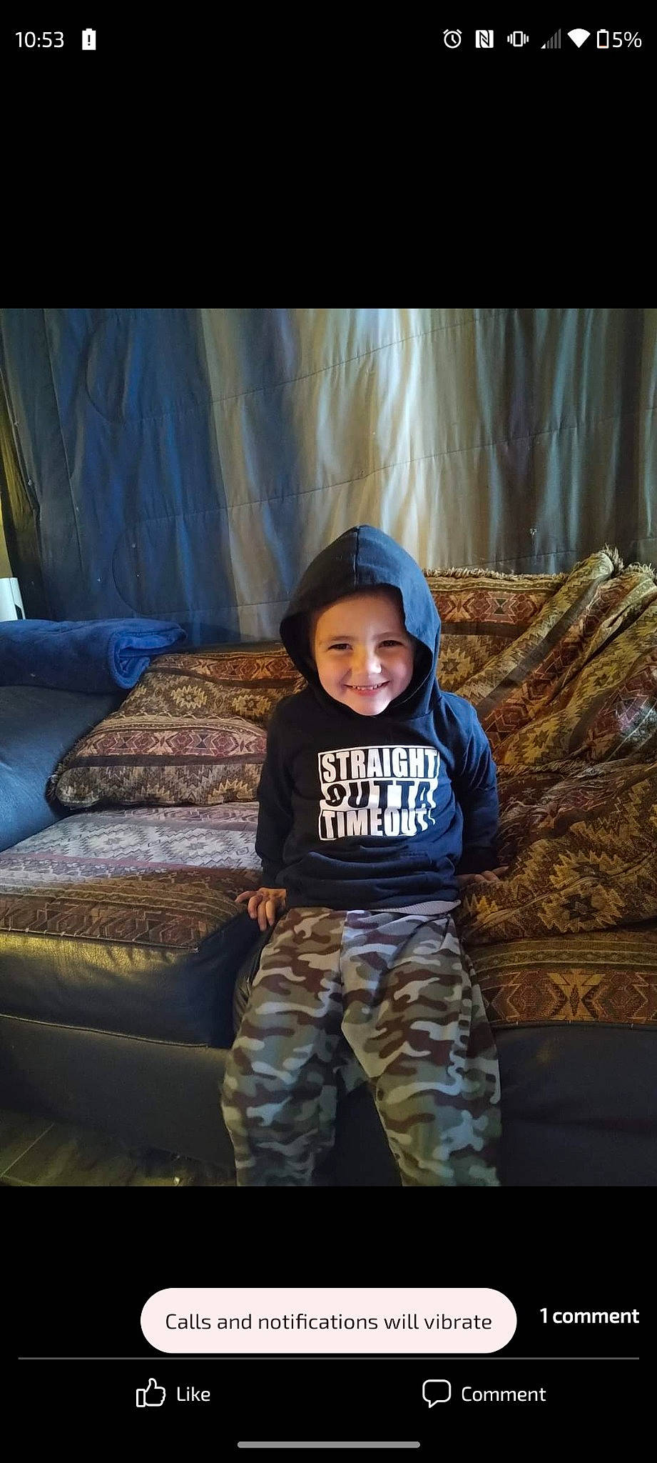 Kylar is registered to the contest to win money with this photo: baby_toddler_clothing, cap, child, comfort, couch, electric_blue, flash_photography, fun, happy, headwear, joy, linens, person, room, sitting, sleeve, smile, sportswear, t_shirt, throw_pillow