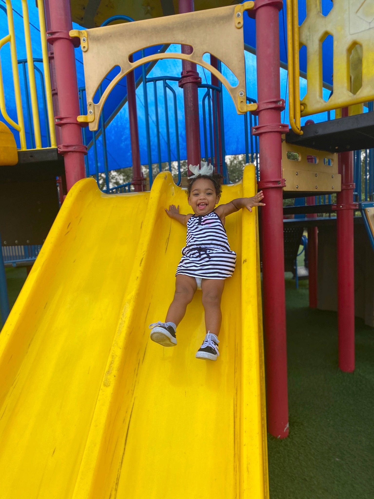 Camila Marie joined the competition — help win amazing prizes! child, chute, fun, human_settlement, joy, leisure, outdoor_play_equipment, person, play, playground, playground_slide, public_space, recreation, yellow