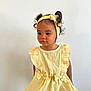 Théa participe au concours pour gagner de l'argent avec cette photo : baby, bow, child, curly_hair, cute, fashion, girl, headband, indoor, innocent, light_background, person, pigtails, portrait, smile, standing, striped_clothing, toddler, yellow_dress, young