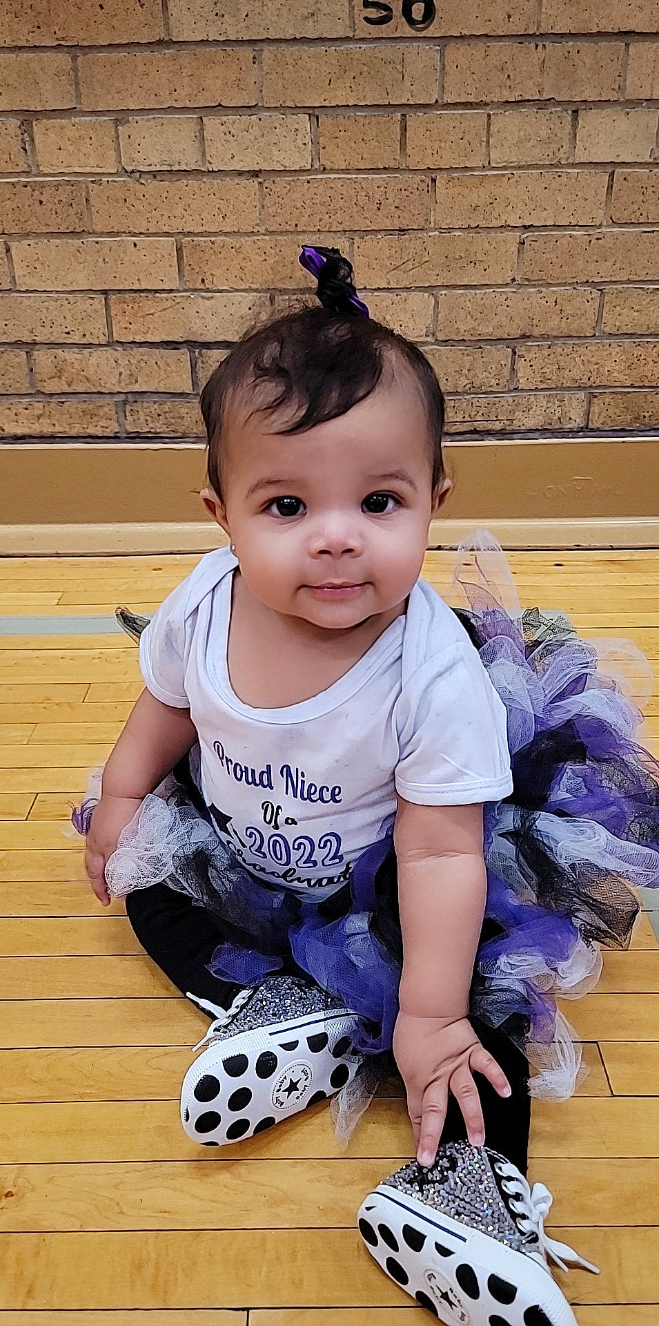 Maria is registered to the contest to win money with this photo: baby, baby_toddler_clothing, blue, child, cool, electric_blue, eyelash, flooring, fun, happy, knee, pattern, person, pink, purple, sitting, sleeve, smile, t_shirt, thigh