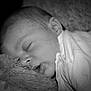 baby, sleeping, infant, black_and_white, blanket, soft_texture, face, closed_eyes, peaceful, newborn, person, portrait, cuddly, rest, cute, cozy, head, skin, clothing, young