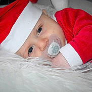 Mattéo participe au concours pour gagner de l'argent avec cette photo : baby, blue_eyes, child, christmas, close_up, cute, face, festive, holiday, indoor, infant, pacifier, portrait, red_clothing, resting, santa_hat, sleepy, soft_texture, toddler, white_fur