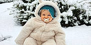 Lyam a rejoint le concours — aidez-le/la à gagner de superbes lots ! baby, building, bush, child, cold, cute, daylight, face, fluffy_clothing, hat, nature, onesie, outdoor, pacifier, person, playful, sitting, smiling, snow, winter