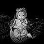 Lyam participe au concours pour gagner de l'argent avec cette photo : baby, infant, knitted_hat, basket, tropical_leaves, black_and_white, portrait, cute, child, soft_lighting, cozy, expression, headwear, bare_chest, feet, hands, sitting, indoors, decor, photography