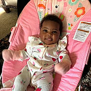 Alana joined the competition — help win amazing prizes! baby, infant, child, pink, baby_rocker, unicorn, strawberry_pattern, clothing, smiling, indoor, carpet, furniture, seat, cute, person, happy, face, home, toy, colorful