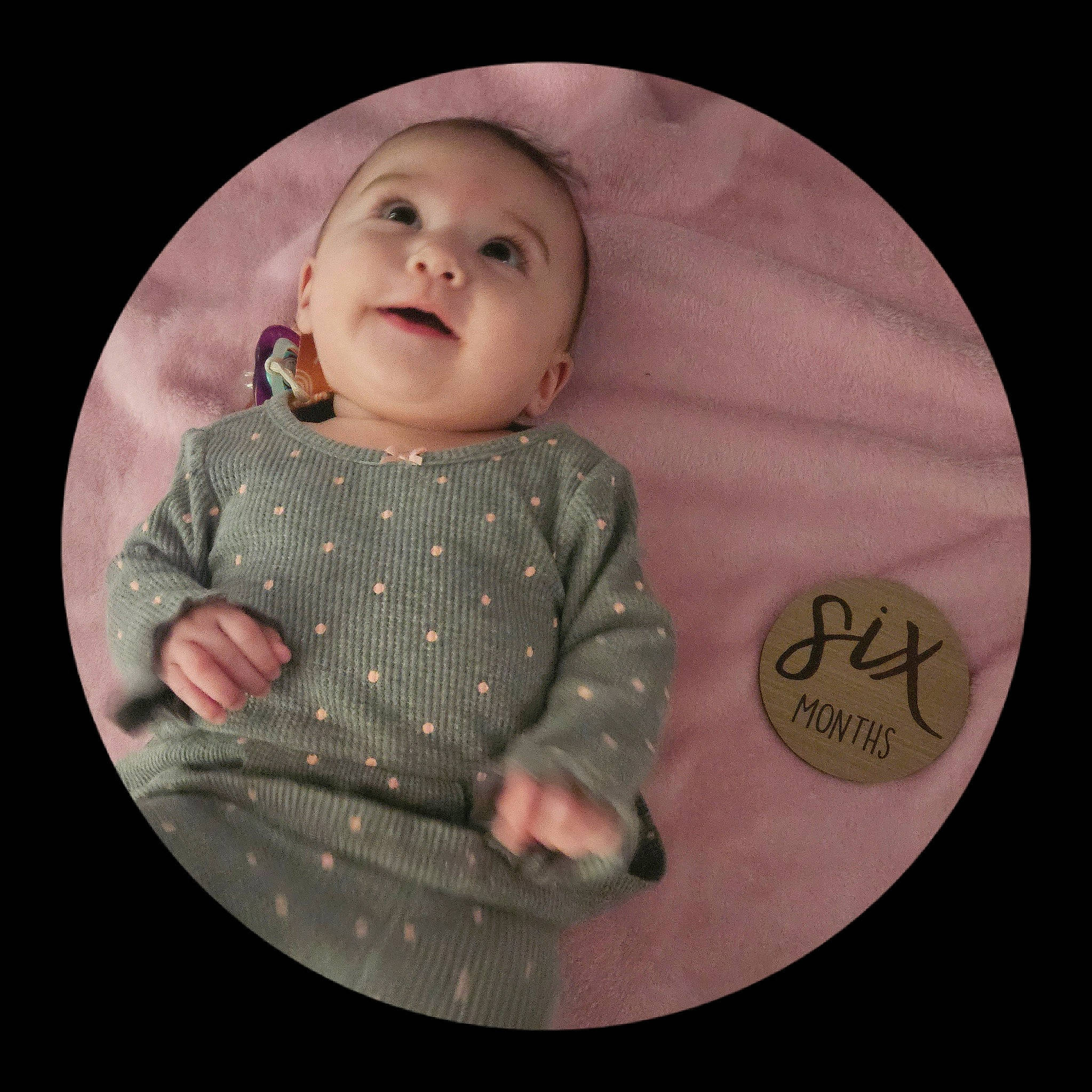 Ocean is registered to the contest to win money with this photo: baby, baby_products, baby_toddler_clothing, bib, cheek, child, circle, dishware, pattern, person, picture_frame, pink, plate, serveware, sitting, skin, sleeve, smile, tableware, toddler