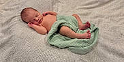 Jonah is registered to the contest to win money with this photo: newborn, baby, sleeping, blanket, soft, green_cloth, peaceful, infant, skin, cute, resting, small, lying_down, indoors, portrait, child, human, relaxing, wrapped, cozy