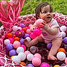 baby, child, clothing, colorful, cute, fun, grass, happy, infant, inflatable_pool, outdoor, person, pink, plastic_balls, play, sitting, skin, summer, toy, young_child