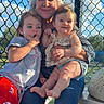 Isabella is registered to the contest to win money with this photo: woman, child, baby, outdoor, bench, sunlight, fence, smile, happy, family, casual_clothing, jeans, shorts, toddler, person, nature, daylight, portrait, grass, blue_sky