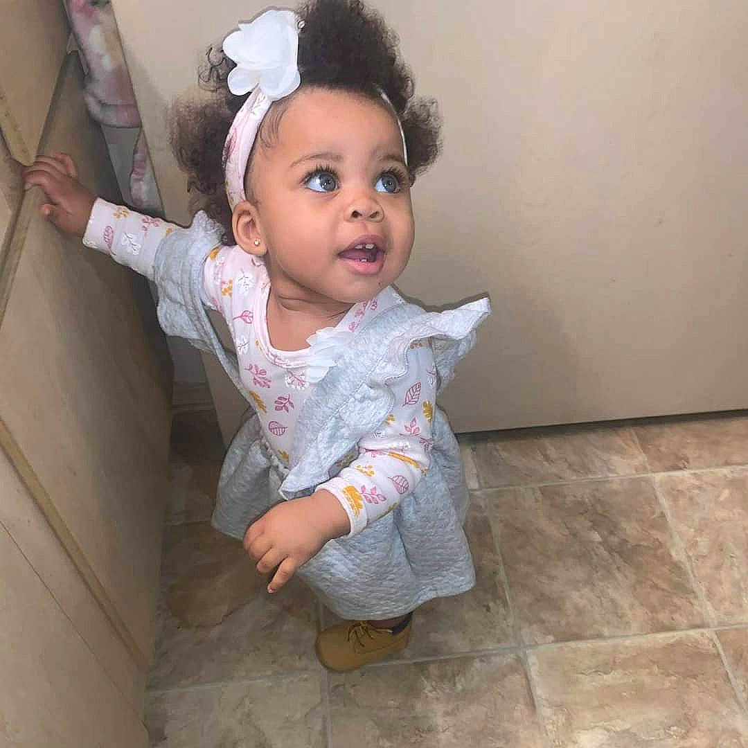Ta'Leah is registered to the contest to win money with this photo: baby, baby_toddler_clothing, cheek, eye, eyelash, face, flash_photography, flooring, fun, hair, happy, head, headband, human_body, lip, nose, person, skin, sleeve, toddler