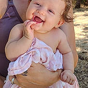 Octavia is registered to the contest to win money with this photo: baby, smiling, happy, child, blanket, holding, adult, outdoor, sunlight, skin, person, portrait, hand, arm, clothing, nature, daylight, cute, infant, toddler