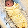 Damian joined the competition — help win amazing prizes! newborn, baby, infant, blanket, swaddled, bassinet, bed, sleeping, cozy, soft, yellow, tortilla_blanket, pillow, fabric, cute, resting, indoors, child, peaceful, wrapped