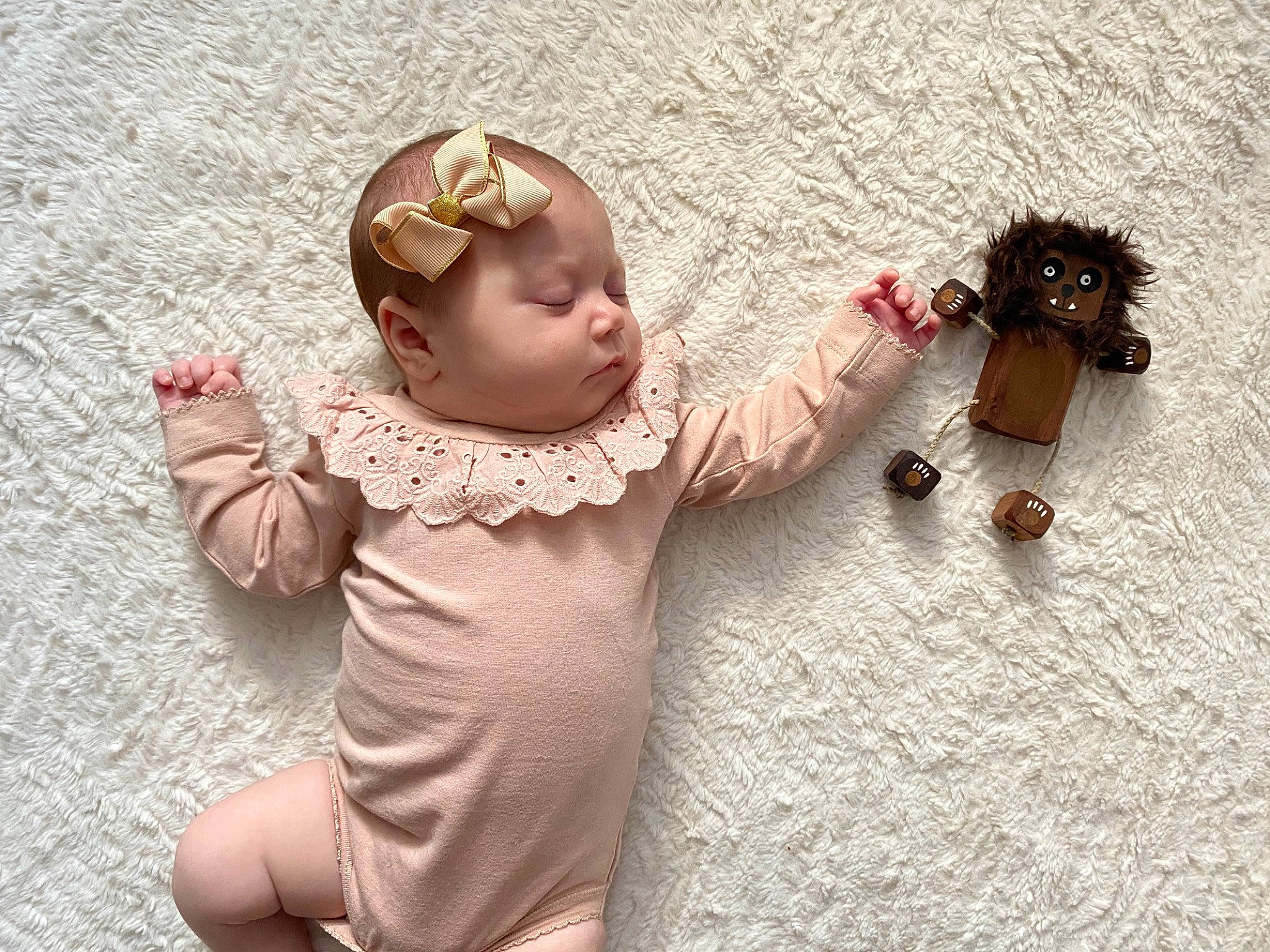 Delilah is registered to the contest to win money with this photo: arm, baby, child, dress, ear, finger, flower, fur, hand, head, joint, person, pink, play, skin, sleeve, t_shirt, toddler, toy