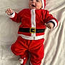 Alex participe au concours pour gagner de l'argent avec cette photo : baby, child, santa_claus_costume, red_clothing, hat, smiling, lying_down, blanket, festive, holiday, cute, face, footwear, infant, christmas, childrens_fashion, warm_clothing, indoors, person, happy
