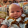 Devin joined the competition — help win amazing prizes! baby, bib, blanket, child, clothing, cozy, cute, dinosaur, expression, face, head, indoor, infant, moose, pattern, person, pillow, portrait, smile, soft
