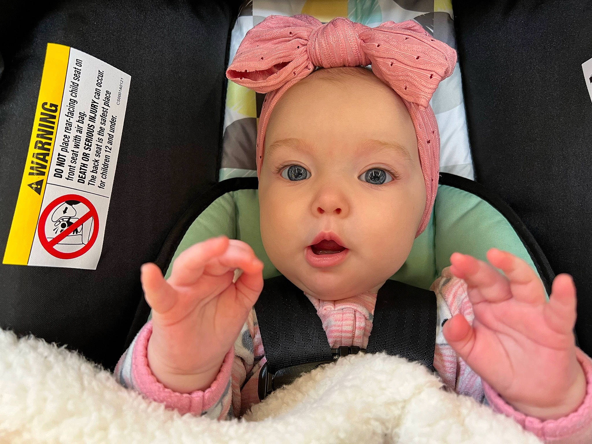 Elliott is registered to the contest to win money with this photo: baby, cheek, comfort, eye, eyelash, finger, gesture, hand, happy, head, headwear, human_body, iris, mouth, nail, nose, person, pink, skin, surprise