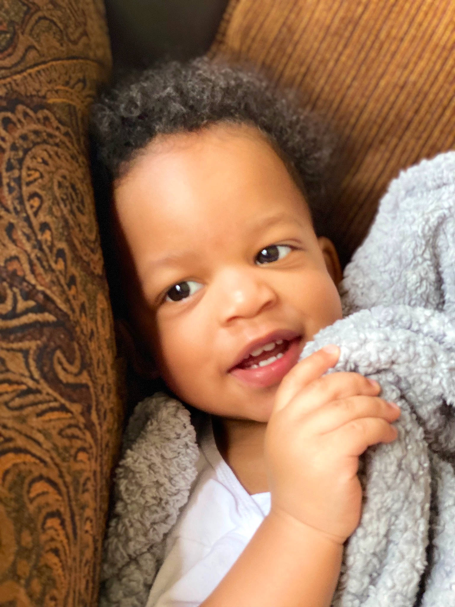 Micah is registered to the contest to win money with this photo: baby, black_hair, cheek, child, chin, eye, eyebrow, eyelash, flash_photography, gesture, hair, happy, head, iris, lip, long_hair, nose, person, skin, smile