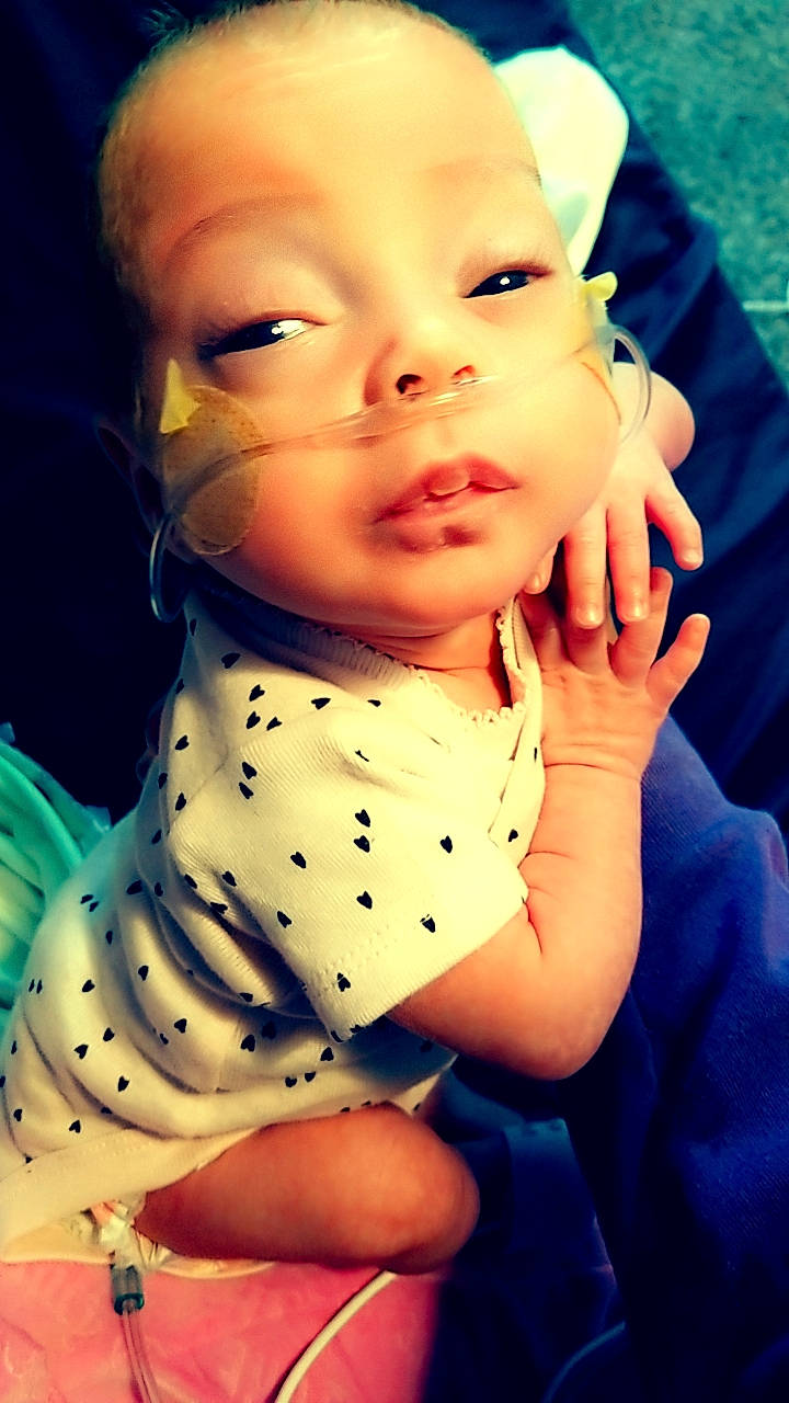 Raven is registered to the contest to win money with this photo: baby, baby_toddler_clothing, cheek, electric_blue, eyelash, finger, flash_photography, fun, gesture, happy, iris, lip, mouth, nail, nose, pattern, person, skin, sleeve, thumb