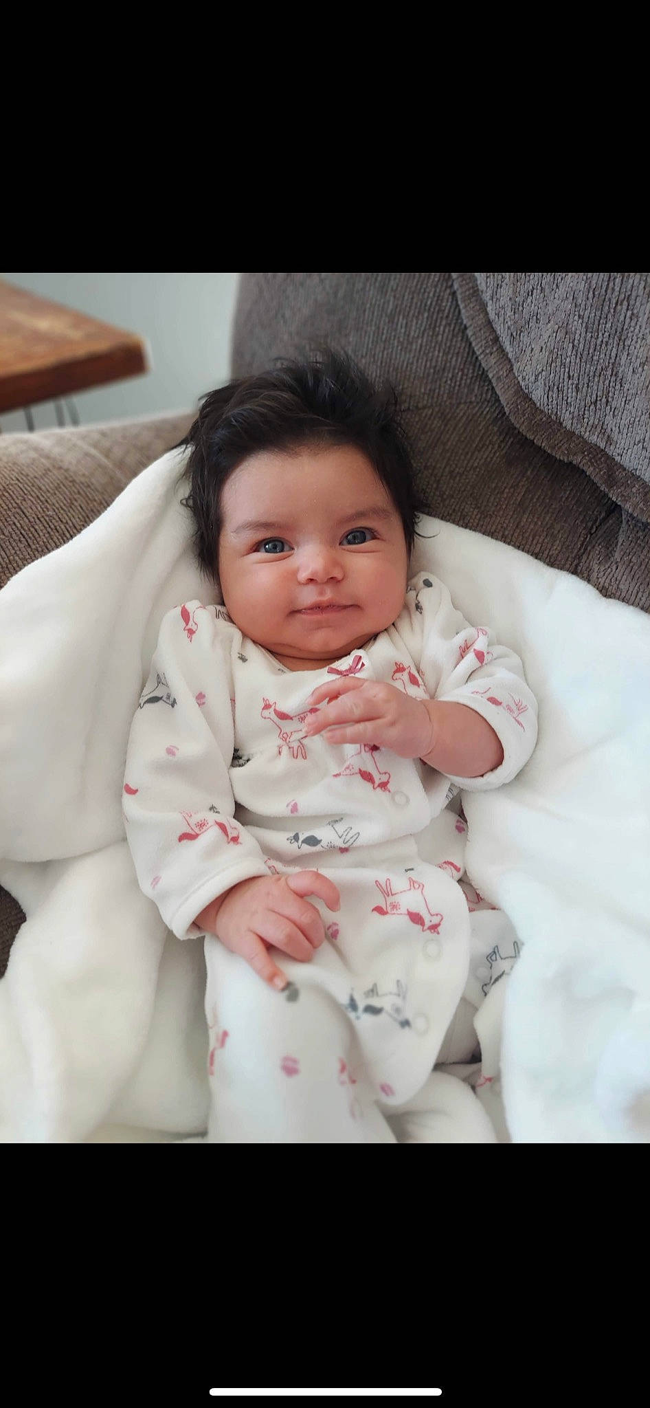 Sophia is registered to the contest to win money with this photo: arm, baby, baby_toddler_clothing, cheek, child, collar, comfort, eye, eyebrow, flash_photography, gesture, hand, happy, iris, lip, nose, person, sleeve, smile, textile