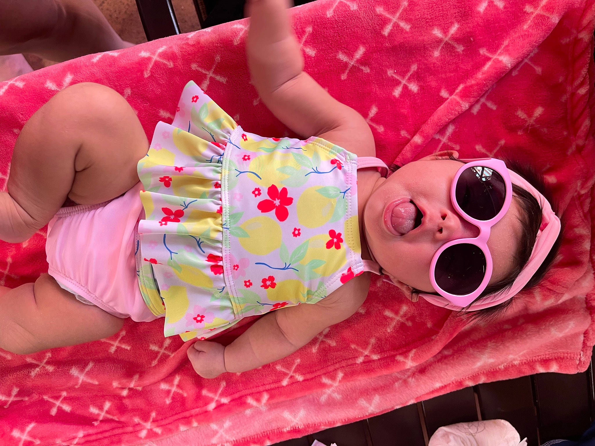 Sophia is registered to the contest to win money with this photo: baby_toddler_clothing, child, comfort, event, face, fun, happy, head, human_leg, magenta, pattern, person, pink, skin, smile, sunglasses, sweetness, textile, thigh, toy